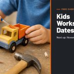 Child painting a wooden toy dump truck kit at a workbench next to a hammer